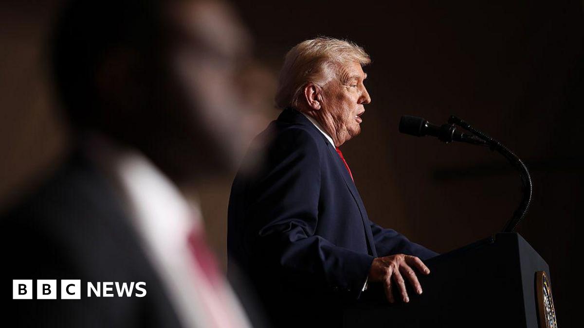 Donald Trump, seen in profile, stands at a podium to deliver a speech in Iowa on Tuesday.