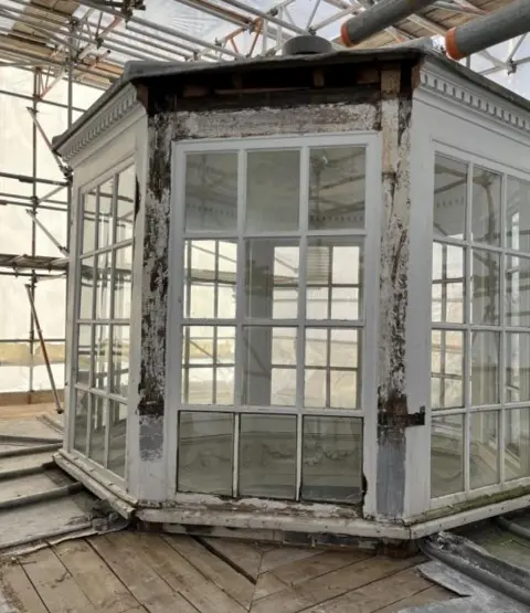 Susan Amaku, Woodhall Planning and Conservation An eight-sided "lantern" roof light, surrounded by scaffolding. Each of the eight sides has a 12-panel window with white frames.