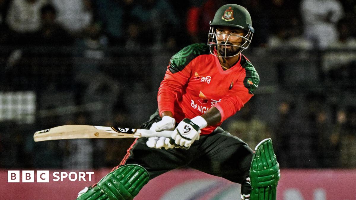 Litton Das batting for Bangladesh in a largely red shirt and green helmet, pads and trousers