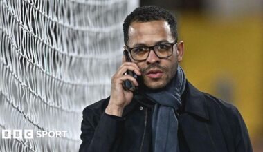 Liam Rosenior on the phone while walking next to one of the goals at Fulham