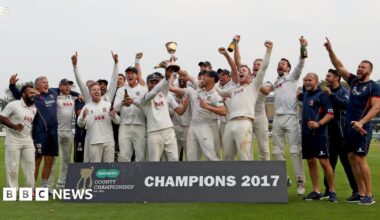 Prime Minister Mark Carney, wearing a black suit jacket, and a white button-up shirt leans his chin on his hands. He has short grey and black hair and is looking away from the camera.