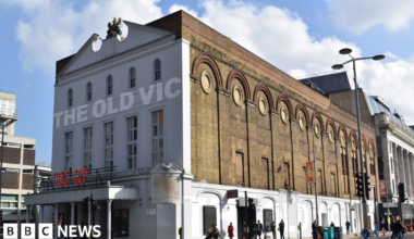 The Old Vic theatre - a large brick building which as a canopy held up by columns on the front. The Old Vic is written across the face of the building