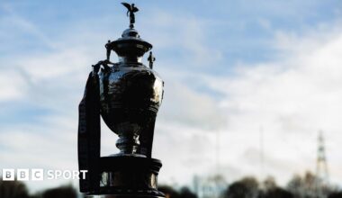 Joel Farrell celebrates with a muscle-flexing pose after scoring for Sheffield against Whitehaven, as opposing players look on ruefully