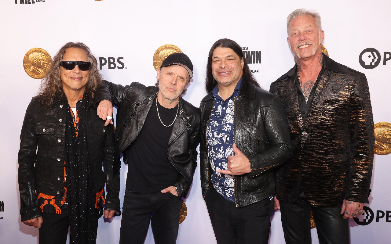 Metallica on a red carpet smiling in 2024