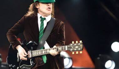 Why does AC/DC guitarist Angus Young wear a school uniform?