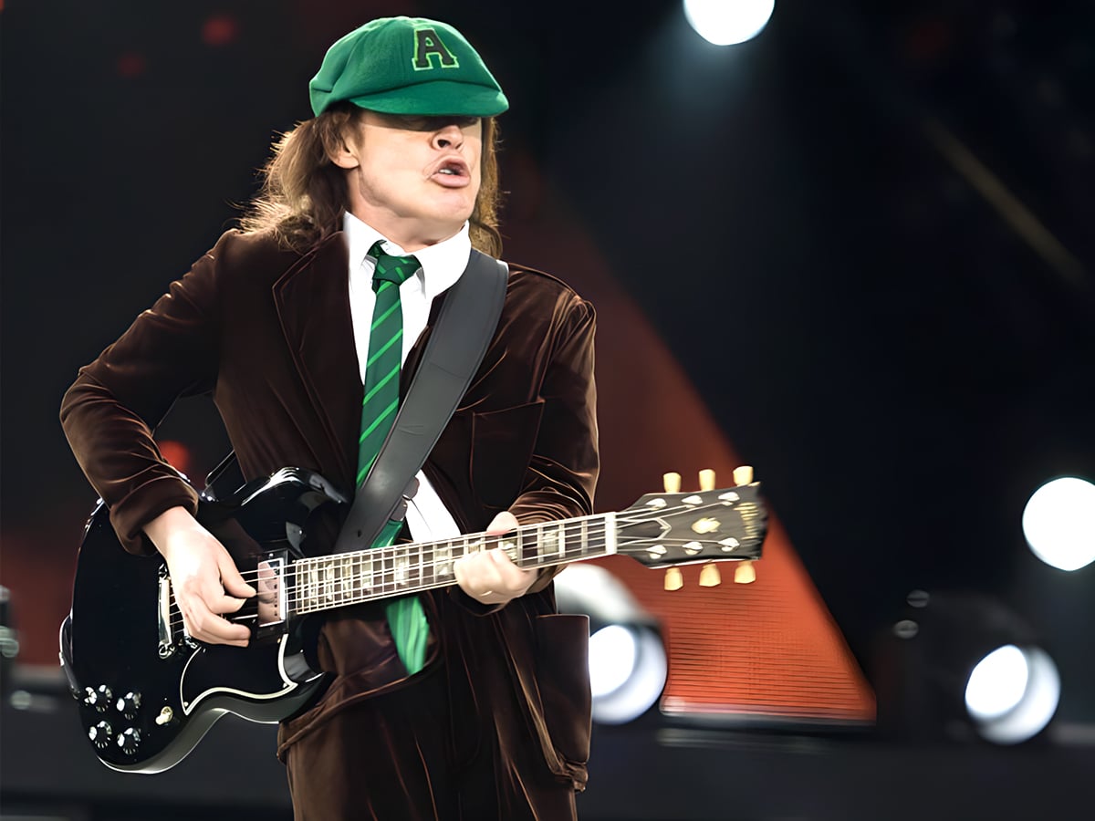 Why does AC/DC guitarist Angus Young wear a school uniform?