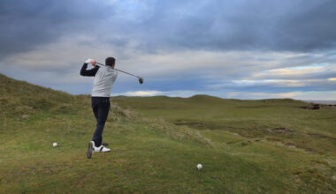 Golfer on a links course on a cold, overcast day.