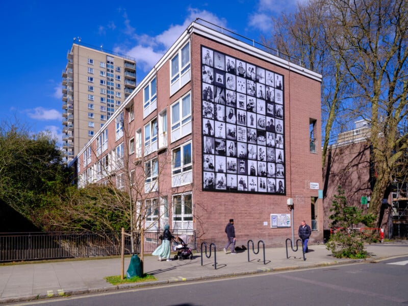 A building with a wall of pictures on it.