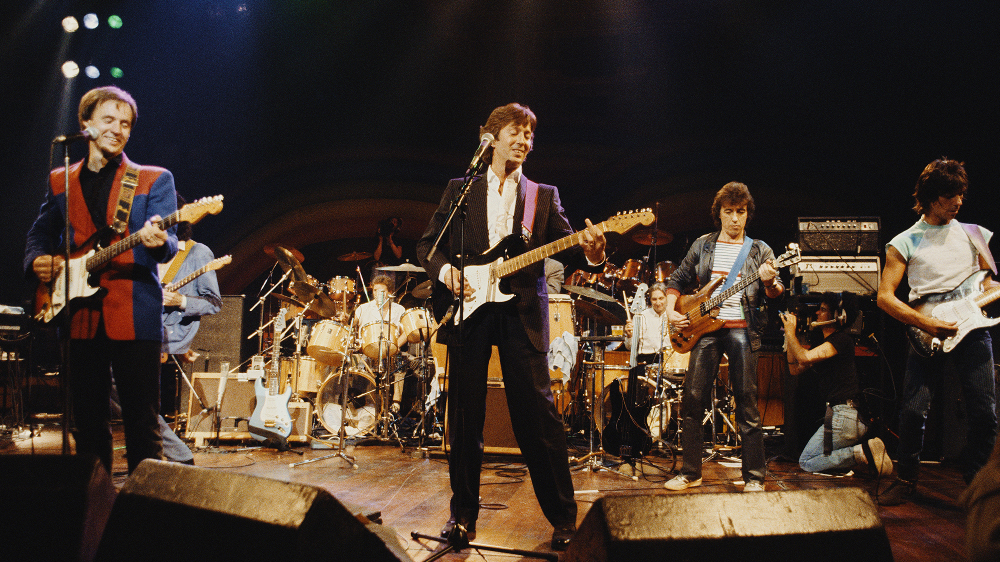An all-star lineup performing on stage at a charity concert for ARMS (Action into Research for Multiple Sclerosis), held at the Royal Albert Hall, London, 20th September 1983. Left to right: Steve Winwood (keyboards), Andy Fairweather Low (standing in front of Jimmy Page), Kenney Jones (drums), Eric Clapton, Charlie Watts (drums), Bill Wyman and Jeff Beck.