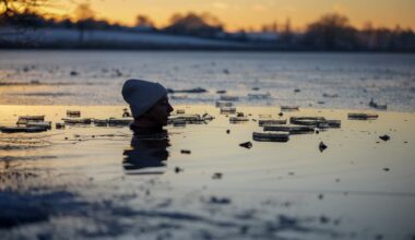Cold water swimmer Autumn Lea takes a freezing dip at sunset in the icy waters of Pickmere Lake. (Photo: Christopher Furlong/Gettty Images)