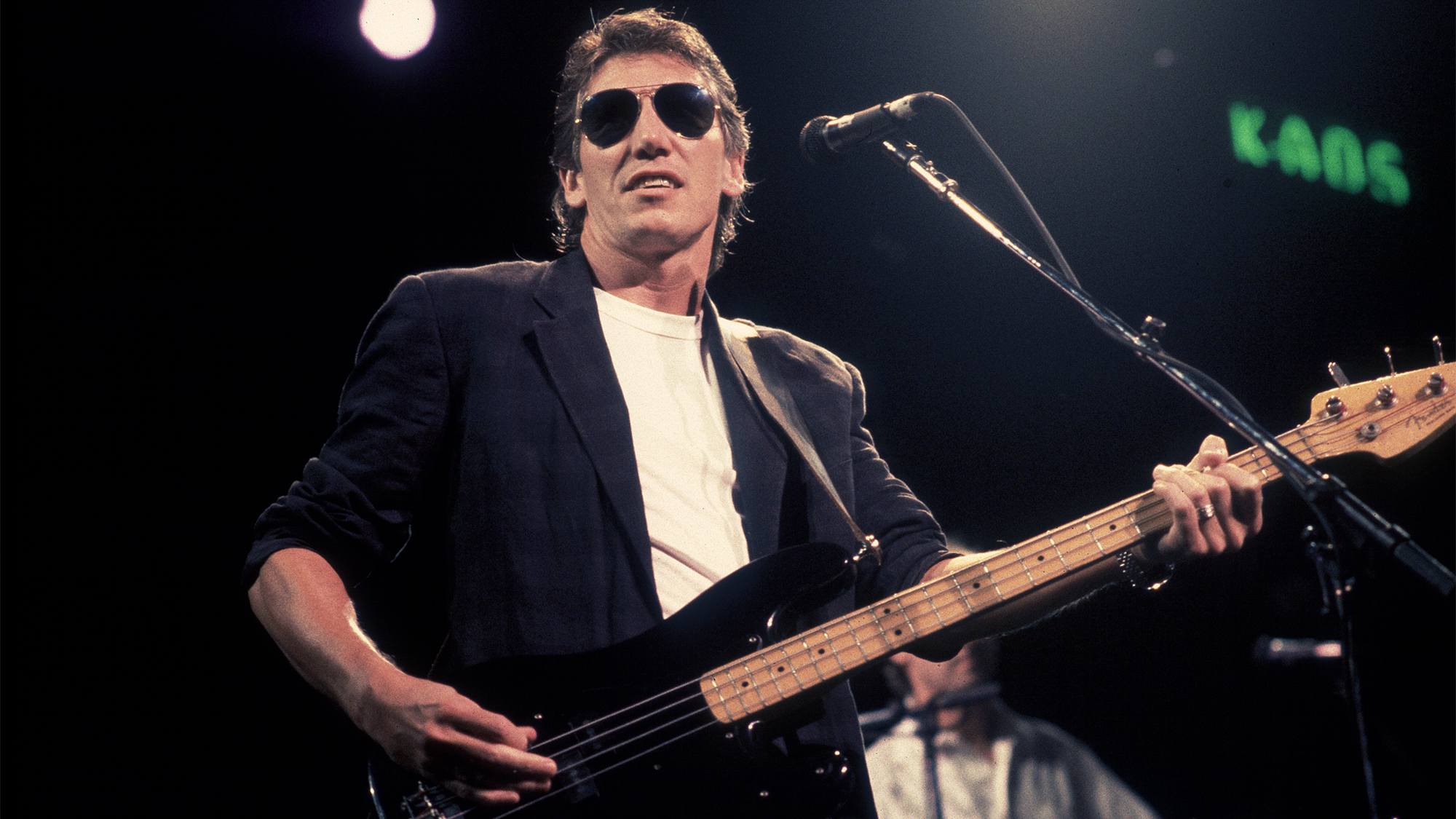 English Rock musician Roger Waters plays bass as he performs onstage at the Poplar Creek Music Theater, Hoffman Estates, Illinois, September 9, 1987.