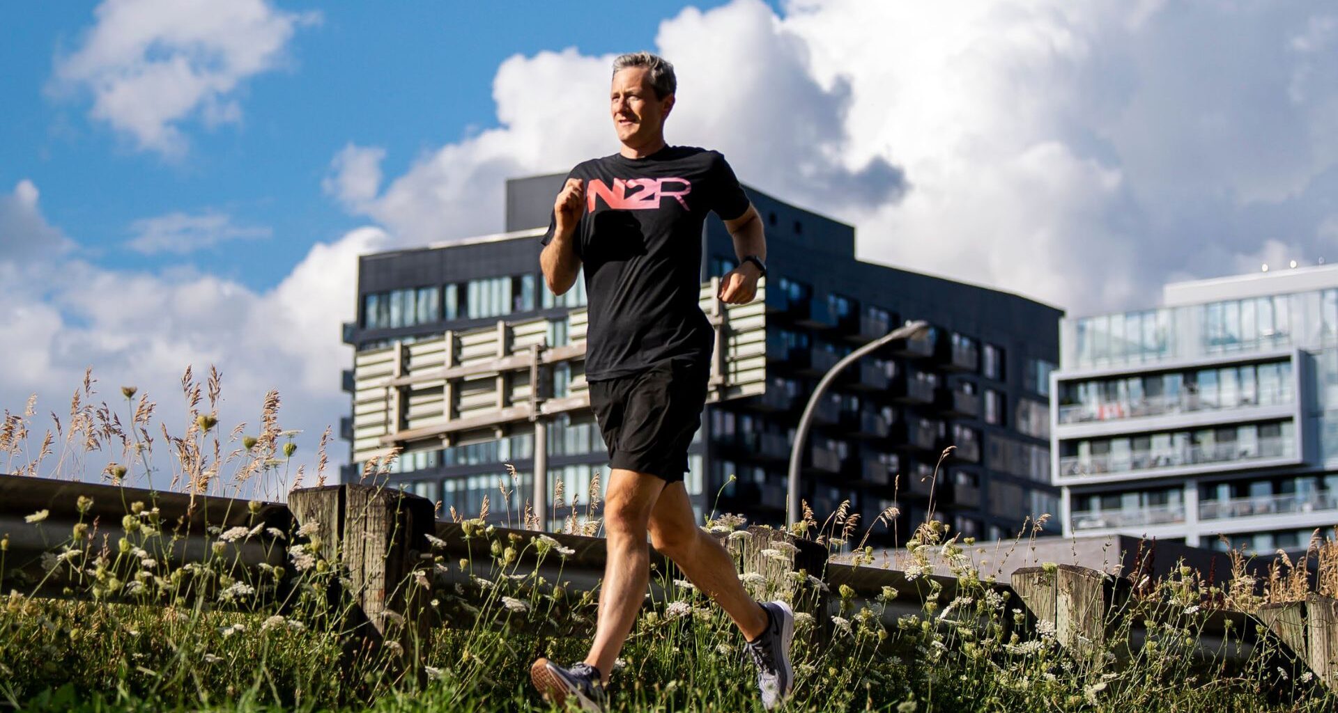 Man runs outside in long grass