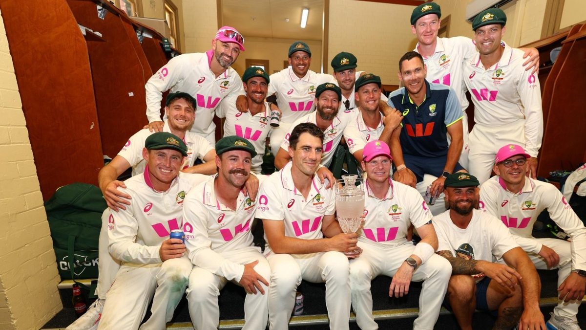 Australia players pose with the Ashes trophy in the SCG dressing rooms