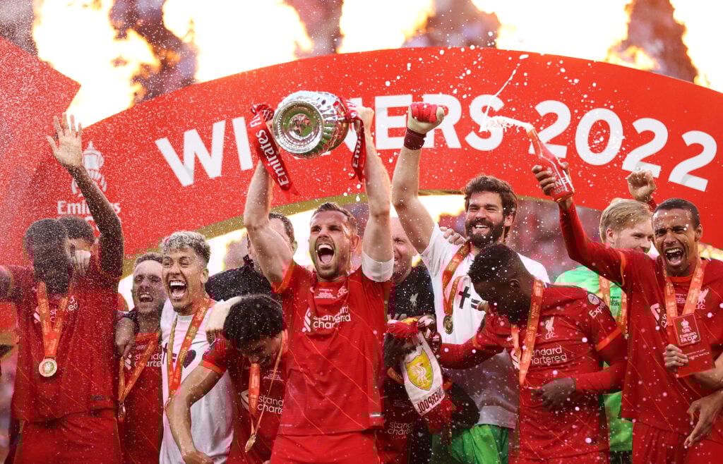 Jordan Henderson of Liverpool lifts The Emirates FA Cup trophy after their sides victory during The FA Cup Final match between Chelsea and Liverpool at Wembley Stadium