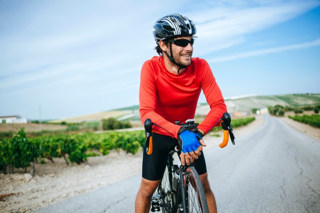 Portrait of man smiling while cycling.