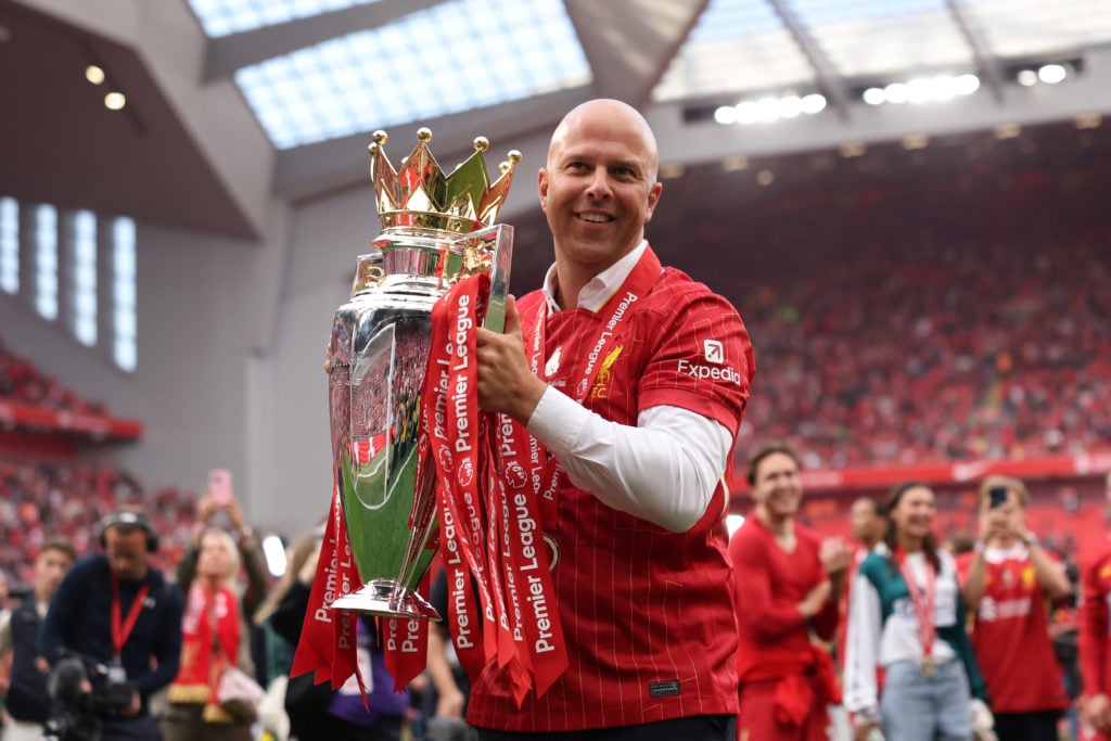 Arne Slot lifts the Premier League title in front of the Kop at Anfield