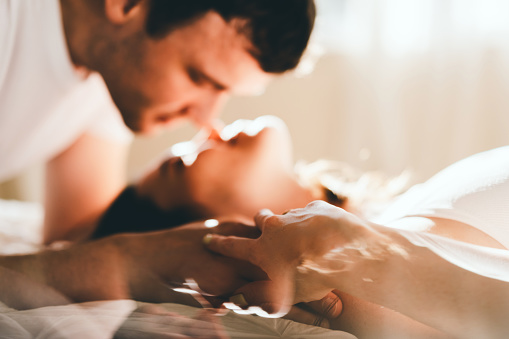 A romantic couple enjoying an intimate moment together in a cozy setting