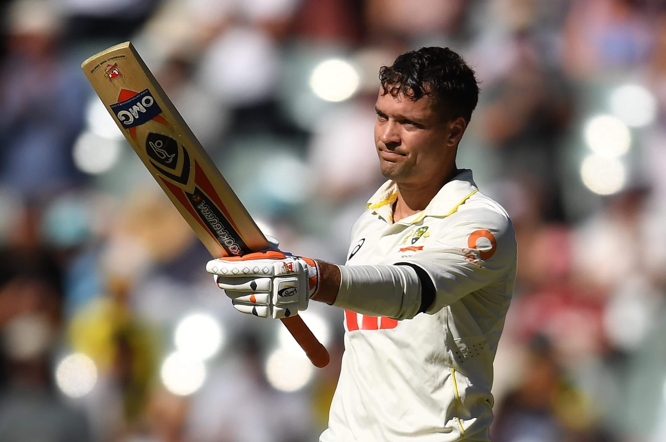 Alex Carey raises his bat after reaching his century at Adelaide