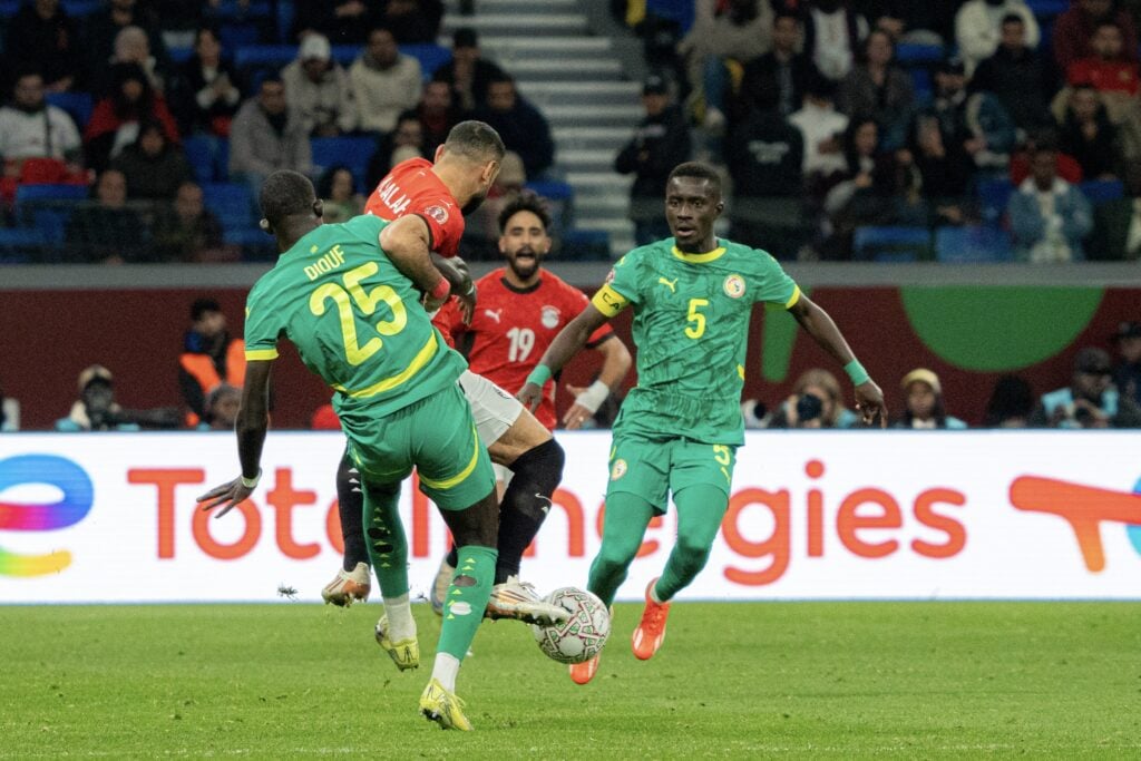 Malick Diouf tackles Mohamed Salah during Senegal vs Egypt in the AFCON semi-finals.