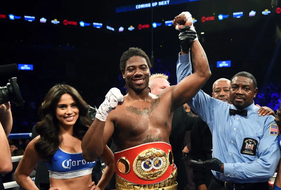 Charles Martin of the US (C) celebrates after winning against Vyacheslav Glazkov of the Ukraine in their IBF World Heavyweight Championship bout at Barclay's Center in New York's borough of Brooklyn on January 16, 2016.