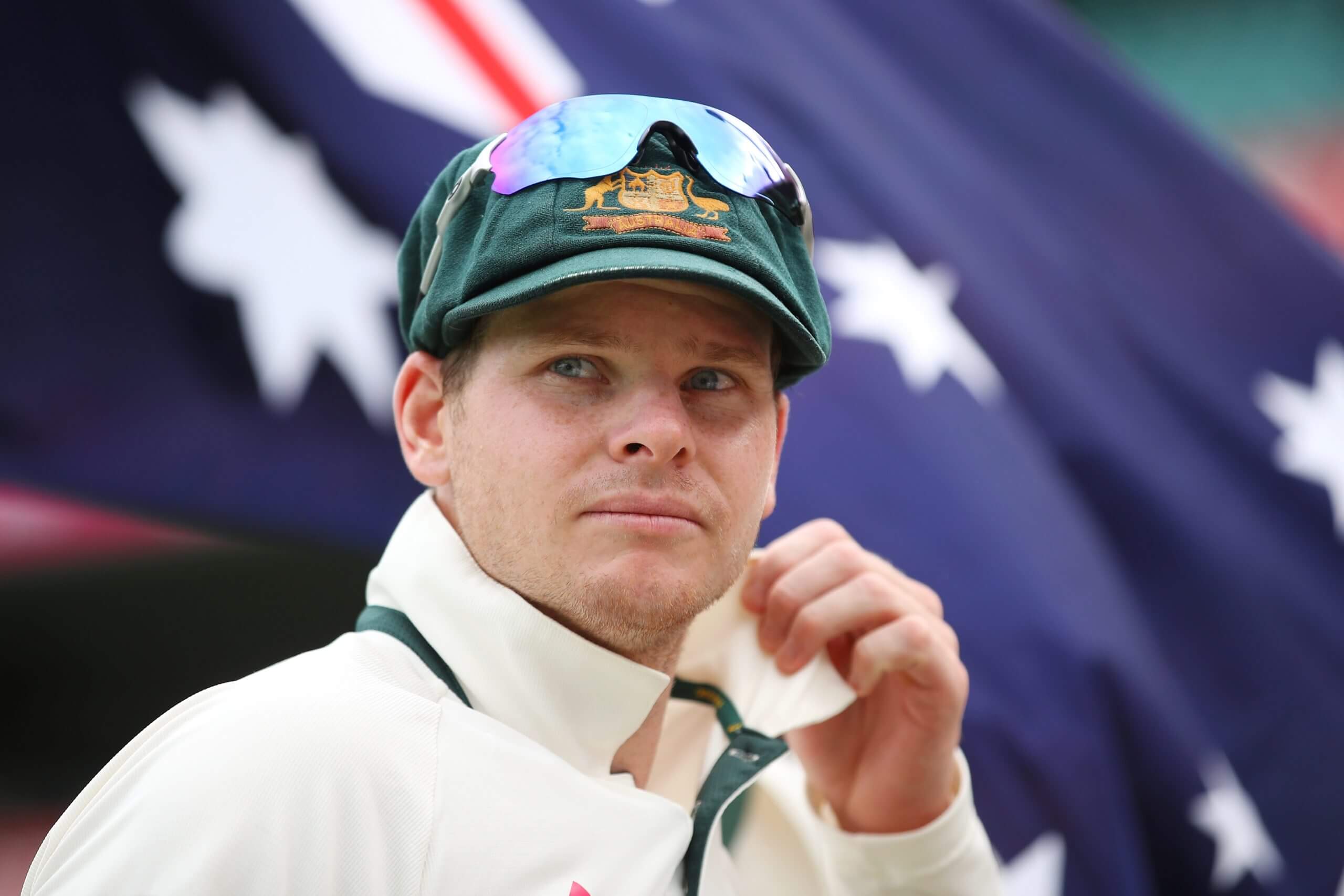 Steve Smith stands in front of an Australian flag
