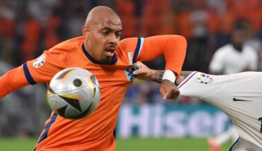 Donyell Malen chests the ball to control it while playing in the orange shirt of the Netherlands