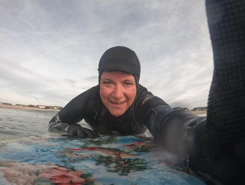 Former Met Police officer Kirstie Coy-Martin on her surfboard which she has described as her ‘safe space’
