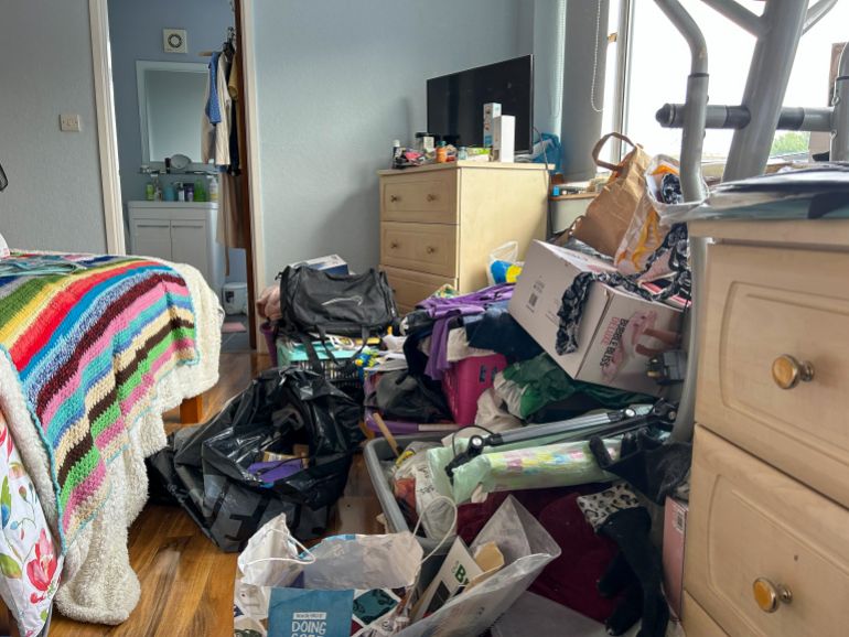 An example of hoarding seen halfway through a cleanup. [Amandas Ong/Al Jazeera]