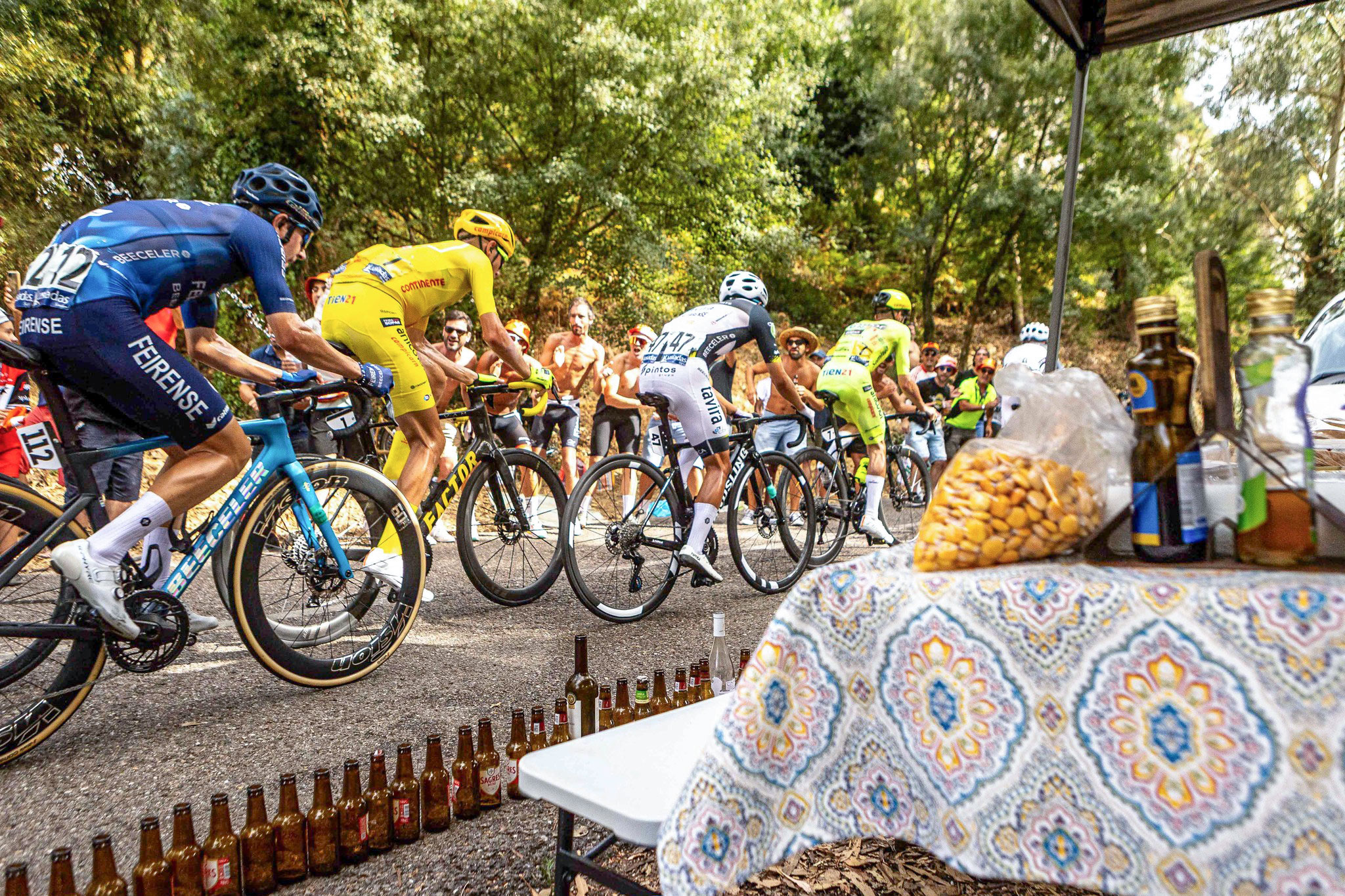 Riders race by fans on stage 9 of the Volta a Portugal 2025