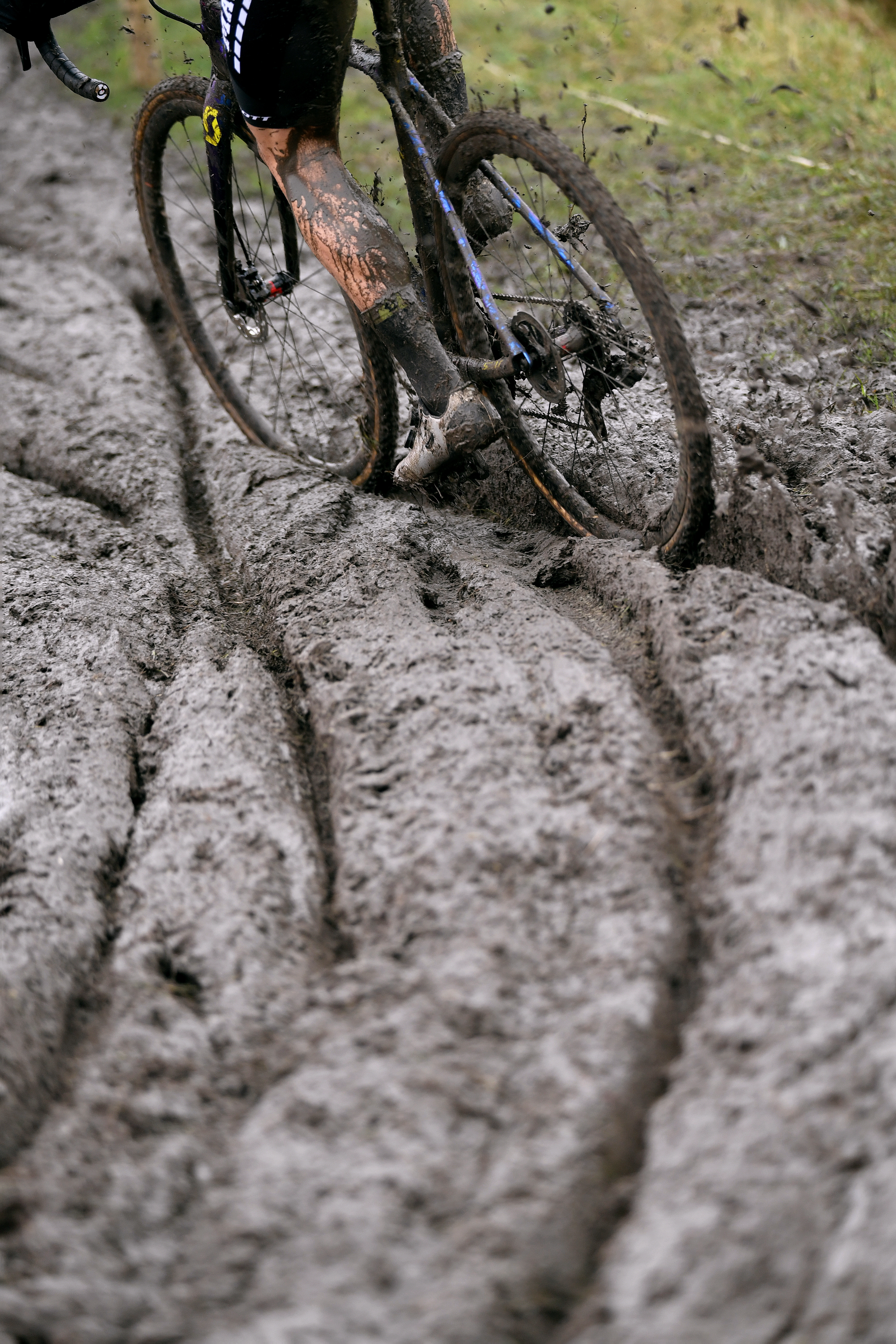 A cyclo cross racer riding through mud