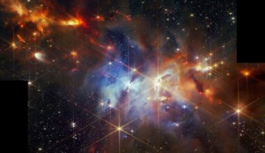 Glowing swirls of purple and orange gas mix with bright twinkly stars against a dark deep space background