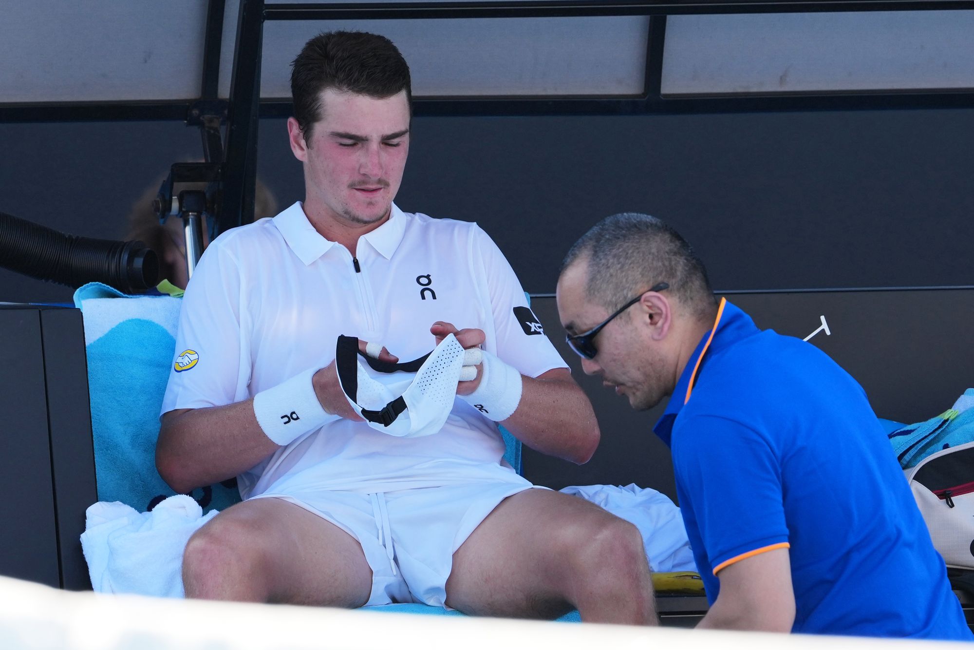 Fonseca receives treatment from a trainer during his four-set defeat