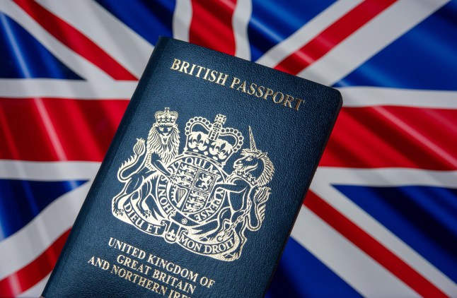 In this photo illustration a United Kingdom issued passport is seen in front of a union jack flag displayed