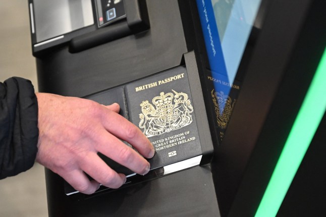 A person as their passport scanned whilst using an Automated European Union Entry/Exit System (EES) kiosk during a press preview on the rollout of the EU's new Entry-Exit System (EES) at Eurotunnel