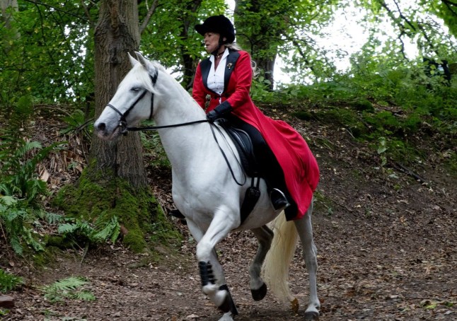 Kim riding Ice the Horse through the woods in Emmerdale