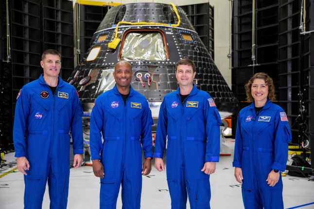 FILE - In this photo provided by NASA, Artemis II crew members, from left, Jeremy Hansen, Victor Glover, Reid Wiseman and Christina Koch, stand together at NASA's Kennedy Space Center in Florida, in front of an Orion crew module on Tuesday, Aug. 8, 2023. (Kim Shiflett/NASA via AP, File)