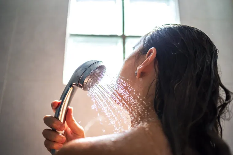 Unrecognizable woman showering