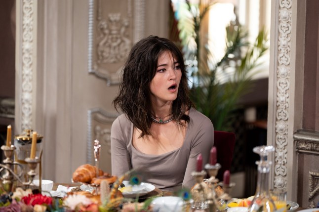 Jade with her mouth agape at the breakfast table, appearing shocked on The Traitors.