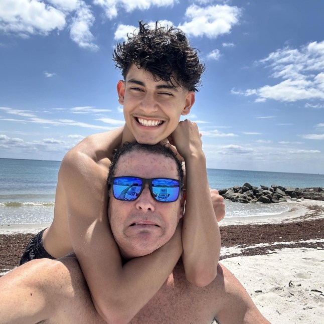 Pictured is Luis Guembes with father Luis Snr This is the first picture of a schoolboy footballer who was stabbed to death in a country park in Guildford this week. Luis Guembes, 15, seen here smiling and hugging his father on a recent family holiday, was found with knife wounds after being attacked on Monday evening. The teenager, who was originally from Peru, attended All Hallows Catholic School in Farnham and had won trophies playing for youth soccer teams. The boy, who also used the name Gabriel, died from injuries inflicted by an attacker at Peacock Wood in Stoke Park on the outskirts of the Surrey town. Images provided via Jacob Dirnhuber