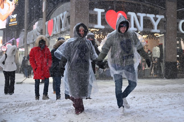 Mandatory Credit: Photo by Erik Pendzich/Shutterstock (16429909y) People walk on snow covered streets in Times Square during a winter storm on January 25, 2026 in New York. Winter storm impacts New York City, USA - 25 Jan 2026
