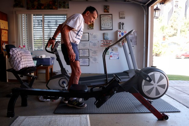 Peter Saccone, 82, works out in his garage at his home in Lemon Grove on Friday, January 16, 2026. Saccone, a former ultramarathoner and retired elementary school teacher - keeps exercising each day an is an adcocate for a living a healthy lifestyle. (Sandy Huffaker / For The San Diego Union-Tribune)