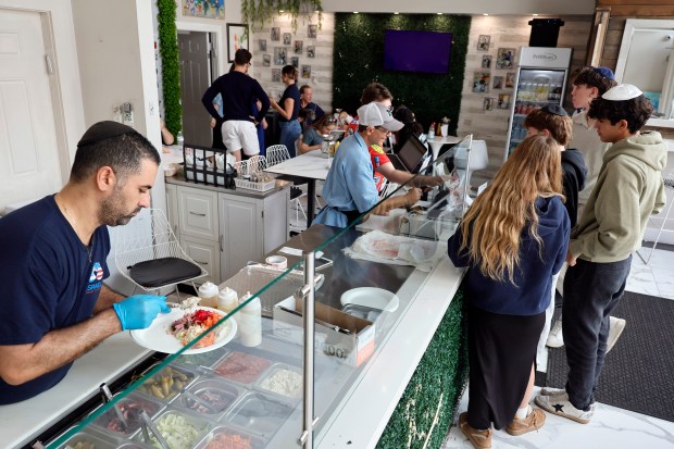 Cook Tomer Levi, plates a customer's order at Friendship Grill in Fort Lauderdale on Monday, Jan. 5, 2026. (Amy Beth Bennett / South Florida Sun Sentinel)