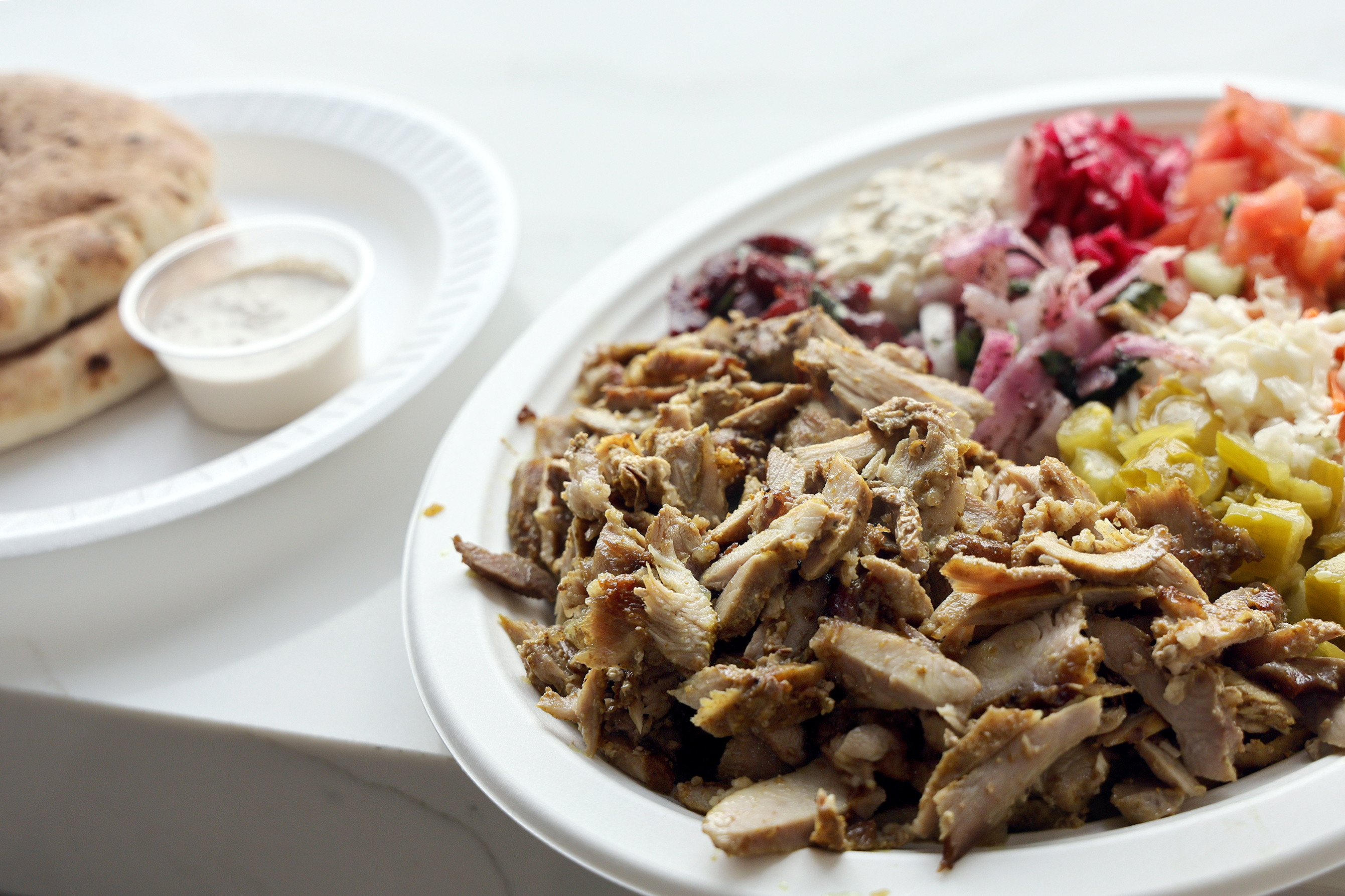 A shawarma plate with pita is shown at Friendship Grill...