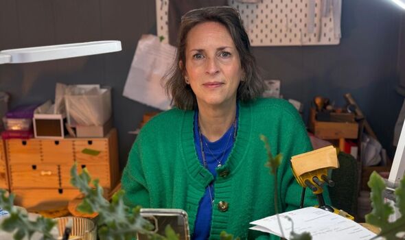 Katie Bird sits at her desk