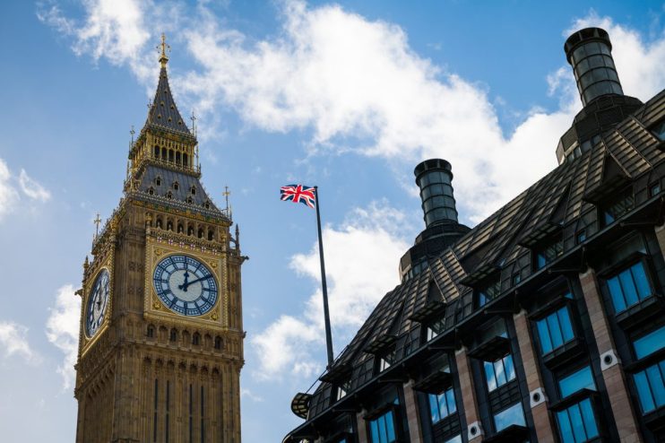 Westminster Parliament building under a cloudy sky, showcasing iconic architecture and historic significance in central Lo...
