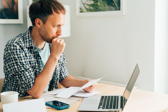 Worried man looking at his laptop