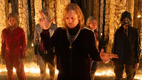 Sony Pictures Erin Kellyman, wearing red, and Jack O'Connell, centre, in 28 Years Later: The Bone Temple 