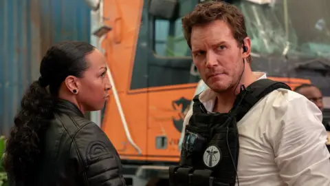 2025 Amazon Content Services LLC True Detective star and professional boxer Kali Reis in a leather jacket, opposite Chris Pratt who's in protective police gear
