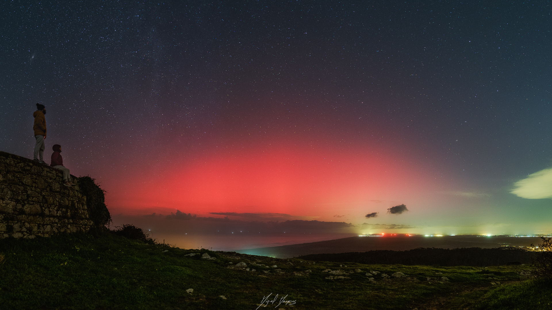 vibrant red light of aurora glows in the sky. 