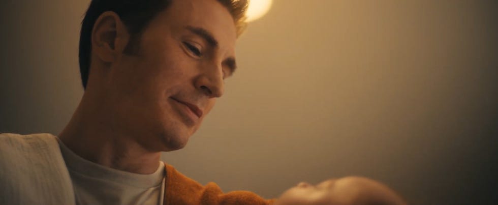 chris evans as steve rogers holding a baby in a softly lit environment in avengers doomsday teaser trailer